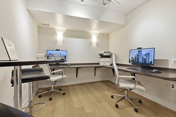 A room with two computer monitors and two chairs